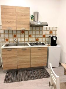 a kitchen with a sink and a stove at Domus Cuseni in Taormina