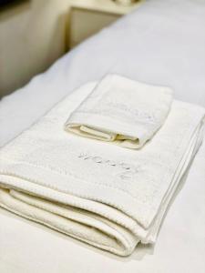 a pile of towels sitting on top of a bed at Duke and Duchess Apartments and Rooms - Private in Room Hot Tub Suites in London