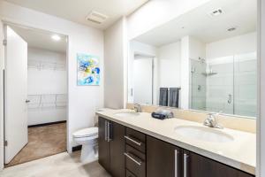 La salle de bains est pourvue d'un lavabo et de toilettes. dans l'établissement 2BR Modern Luxury Oasis WeHo, à Los Angeles