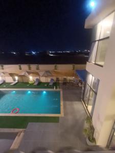 a view of a swimming pool at night at Villa rotana airport road in Al Qasţal