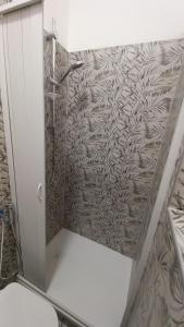a shower in a bathroom with a wall at Matrimoniale francese con bagno privato in Noicattaro +22 photos