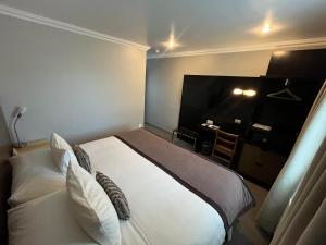 Rúm í herbergi á Hotel Martín Gusinde