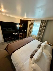 Rúm í herbergi á Hotel Martín Gusinde