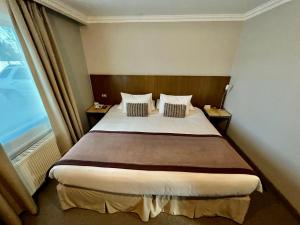 Rúm í herbergi á Hotel Martín Gusinde