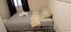 a small bed in a room with two pillows at Za uzivanje u miru in Priboj