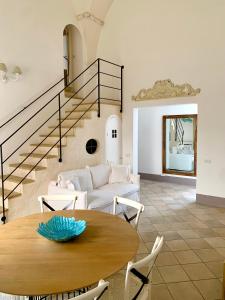 a living room with a table and a couch at Kàllistos Suites & Apartments in Gallipoli