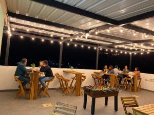 a group of people sitting at tables in a restaurant at VILLA DEL ROSARIO in Tena