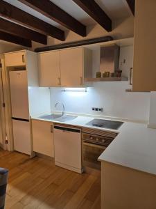a kitchen with white cabinets and a sink at Cathedral Exclusive Flat - Palma in Palma de Mallorca