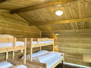 a log cabin with three bunk beds in it at Winjum Cabin Aurland Stegastein in Aurland