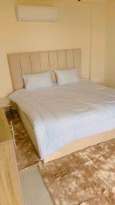 a bedroom with a large bed with white sheets at Amazing Rooftop for rent in Irbid in Irbid