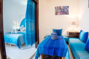 Ένα ή περισσότερα κρεβάτια σε δωμάτιο στο DAR CHEFCHAOUEN