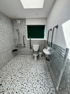 a bathroom with a toilet and a sink at The Chapter Hotels - Finsbury Park in London