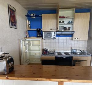 a kitchen with a sink and a stove top oven at Lussen in Regen