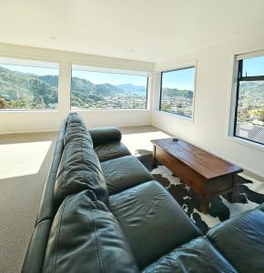 a living room with a couch and a table at Picton Hilltop Apartment in Picton