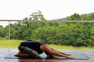 a person doing a yoga pose on a mat at Mission Beach Rural Escape in Mission Beach