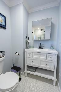 a white bathroom with a sink and a toilet at Beachside Retreat in West Haven