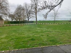 a field of green grass with trees and a fence at Maison lumineuse avec jardin privatif, proche châteaux de la Loire, tennis gratuit et charme historique - FR-1-581-69 in Châteaudun