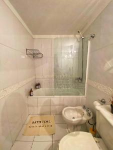 a bathroom with a tub and a toilet and a sink at Edificio Millenium Apartment in Mendoza