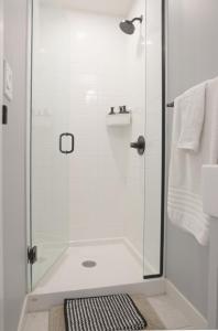 a bathroom with a shower with a glass door at Enchanted Mountain Getaway in Canmore