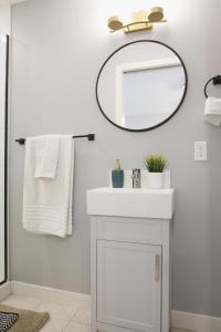 a bathroom with a white sink and a mirror at Enchanted Mountain Getaway in Canmore