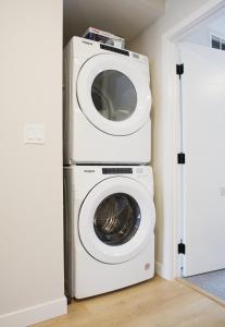 a washing machine and a dryer in a room at Enchanted Mountain Getaway in Canmore