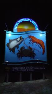 a sign for a fish aquarium with two fishes at Karumba Point Holiday & Tourist Park in Karumba