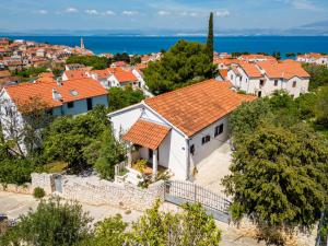 an aerial view of a white house with orange roofs at Holiday house with a parking space Sutivan, Brac - 23075 in Supetar
