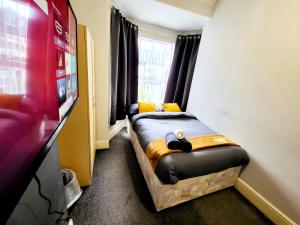 a small bed in a room with a tv at Stay Sleep Rest - De Grey in Hull