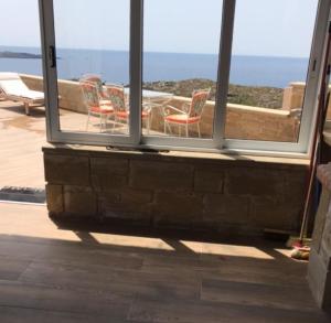 a view of a patio with chairs and a table at Elafonisi Villa above the Beach in Elafonisi