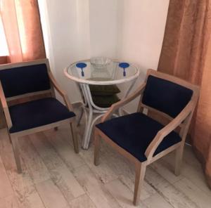 two chairs and a table and a table and chairs at Elafonisi Villa above the Beach in Elafonisi