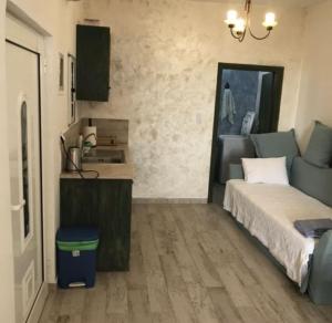 a small bedroom with a bed and a kitchen at Elafonisi Villa above the Beach in Elafonisi