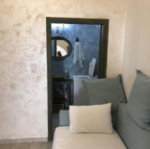 a mirror in a room with a couch and a sink at Elafonisi Villa above the Beach in Elafonisi