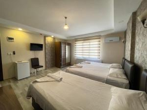 Postel nebo postele na pokoji v ubytování İkarus Hotel