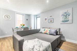 a living room with a couch and a table at Pet Friendly - 1BR Newly Renovated Apartment in Ottawa