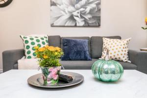 a living room with a table with a pumpkin and flowers at Lowertown Apartment - Sleeps 4 in Ottawa