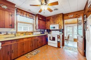 a kitchen with wooden cabinets and a ceiling fan at Town of South Bethany --- 133 Layton Dr in Bethany Beach +12 photos