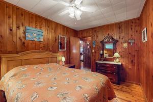 a bedroom with a bed and wood paneled walls at Town of South Bethany --- 133 Layton Dr in Bethany Beach