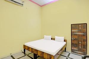 pokój z łóżkiem w rogu pokoju w obiekcie OYO J.M.D Restaurant &rooms w mieście Jhājhar