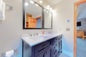 a bathroom with a sink and a mirror at Alpine Abode in Dover +13 photos