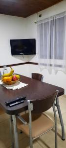 a wooden table with a bowl of fruit on it at La casa del Marino in Ushuaia +23 photos