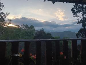 a view of the mountains from the deck of a house at NETHSARA cottage in Ella