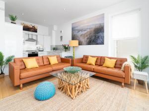 a living room with two couches and a coffee table at 1 Little Beach in Woolacombe