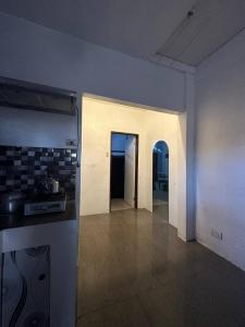 um quarto vazio com uma cozinha e um corredor em House in Coron-The Grey House em Coron