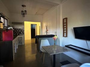a living room with a table and a dining room at House in Coron-The Grey House in Coron