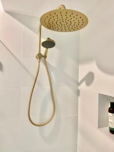 a shower head hanging on a wall in a bathroom at Selby Cottage in Katoomba +25 photos