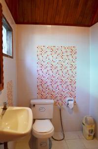 a bathroom with a toilet and a shower curtain with hearts at Sayang Beach Resort Koh Lanta in Ko Lanta