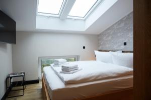 En eller flere senge i et værelse på Binnendiek Haus 1 Deluxe-Apartment 9 + 26 billeder