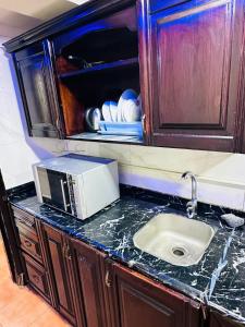 a kitchen counter with a microwave and a sink at Chalet in Porto Sokhna Beach Resort in Ain Sokhna