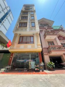a tall building with a store in front of it at Victoria hotel in Ha Long