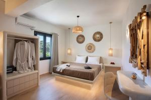 a bedroom with a bed and a bathroom with a sink at Vinebranch Villa in Vourvoulos